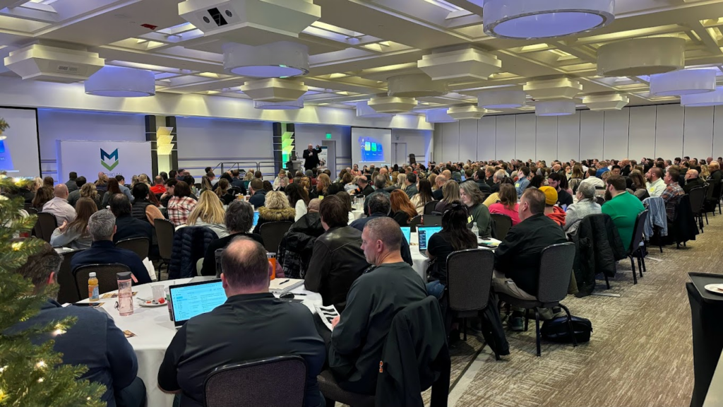 Large group of attendees watching a presentation at the AI Summit 2023.